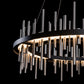 A Hubbardton Forge Circular Cityscape Pendant light fixture with metal rods hanging from it.