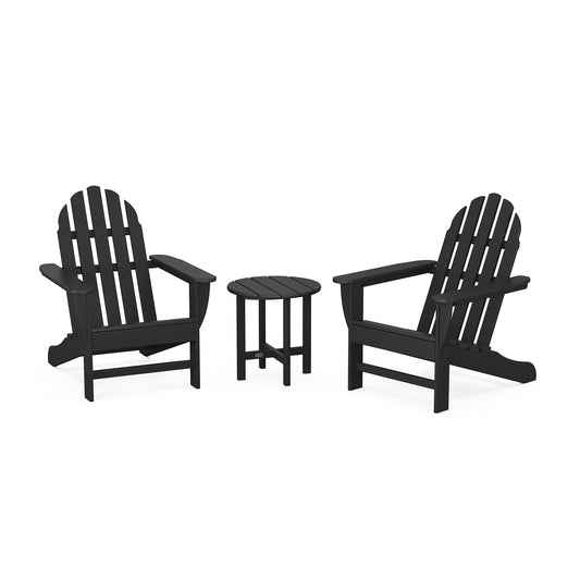 Two black POLYWOOD Classic Adirondack chairs and a small round table set against a white background, demonstrating a simple outdoor furniture arrangement.
