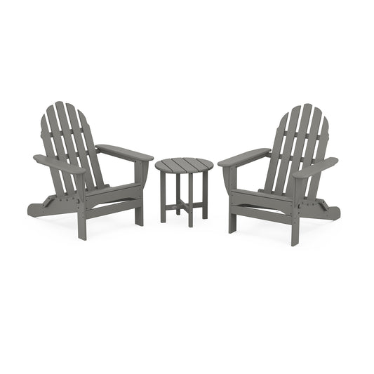 Two gray POLYWOOD® Classic Folding Adirondack 3-Piece Sets facing each other with a small round table in between, set on a plain white background.
