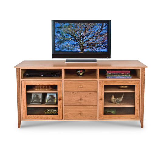 An American-made wooden entertainment center with a Lyndon Furniture Classic Shaker 64" Media Center on top.