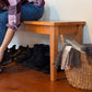 Lyndon Furniture Classic Shaker Bench with a person seated while putting on boots.