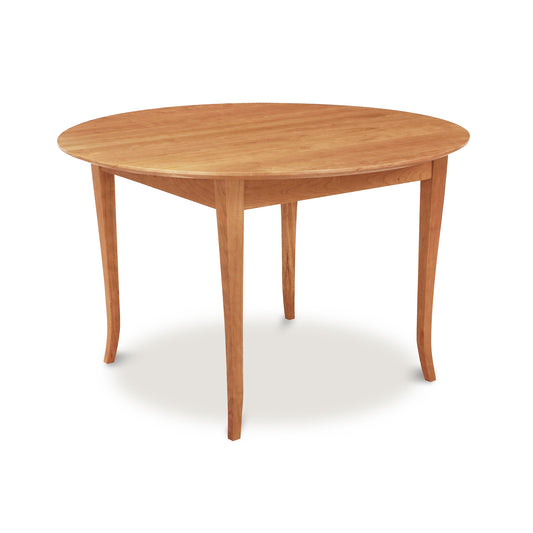 The Classic Shaker Flare Leg Round Solid Top Table by Lyndon Furniture features a wooden top and legs, crafted from solid hardwoods using traditional joinery techniques.