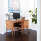 A Small Wood Flare Leg Executive Desk and chair in a home office by Lyndon Furniture.