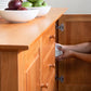 Classic Shaker Large Buffet by Lyndon Furniture with white plates stored in the lower cabinet.