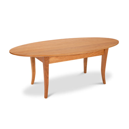A Lyndon Furniture Classic Shaker Flare Leg Oval Top Coffee Table made from sustainably harvested hardwoods on a white background.