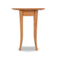 A Classic Shaker Round Flare Leg End Table by Lyndon Furniture with three slender legs, isolated on a white background. The table features a smooth, polished finish highlighting the wood grain.
