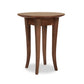 A Classic Shaker Round Flare Leg End Table by Lyndon Furniture with four slender, curved legs on a plain white background. The table appears sturdy and is made of a rich, dark wood.