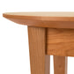 Close-up of a Lyndon Furniture Classic Shaker Round Flare Leg End Table showing the smooth, rounded corner of the tabletop and the detail of the grain on the solid wood leg against a white background.