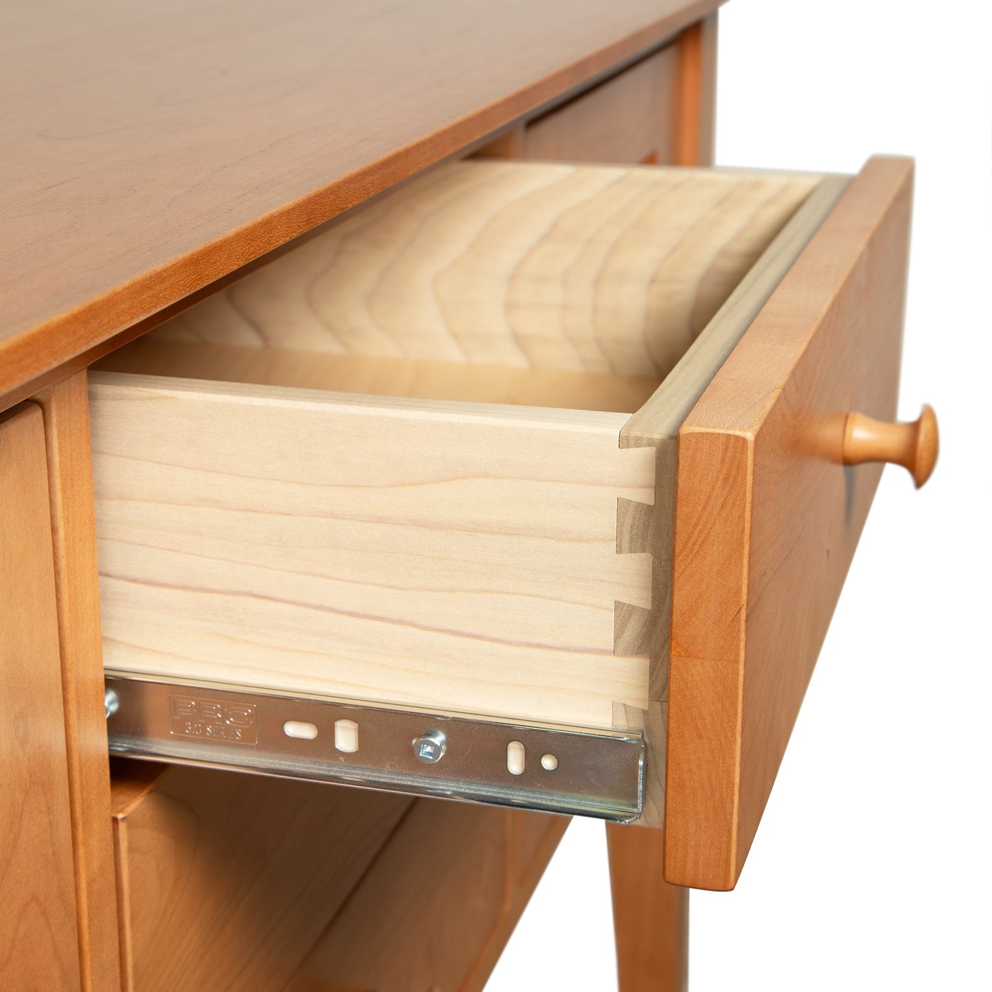 Lyndon Furniture Classic Shaker Small Buffet close-up featuring an open drawer with visible dovetail joinery and metal sliding rail.