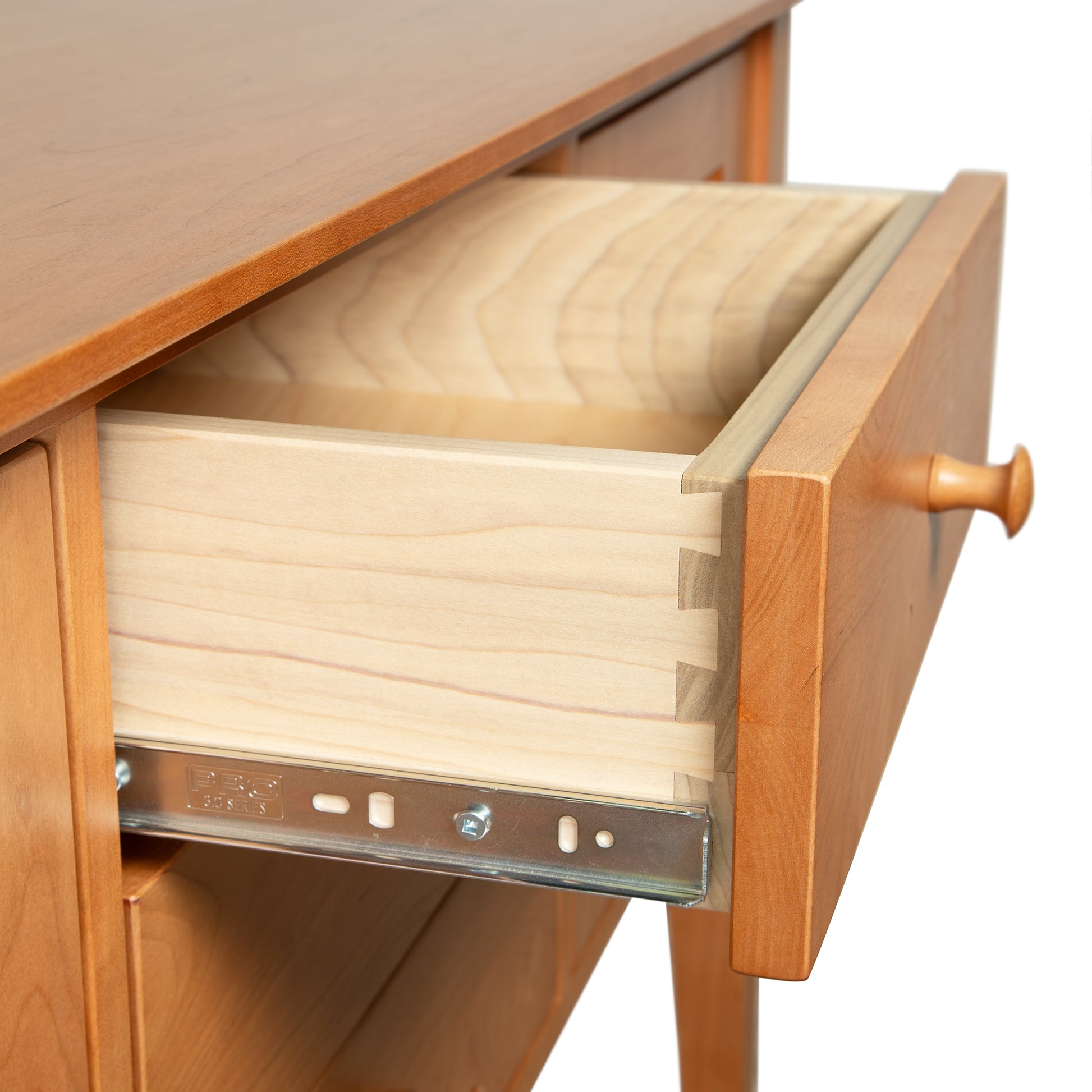 Lyndon Furniture Classic Shaker Small Buffet close-up featuring an open drawer with visible dovetail joinery and metal sliding rail.