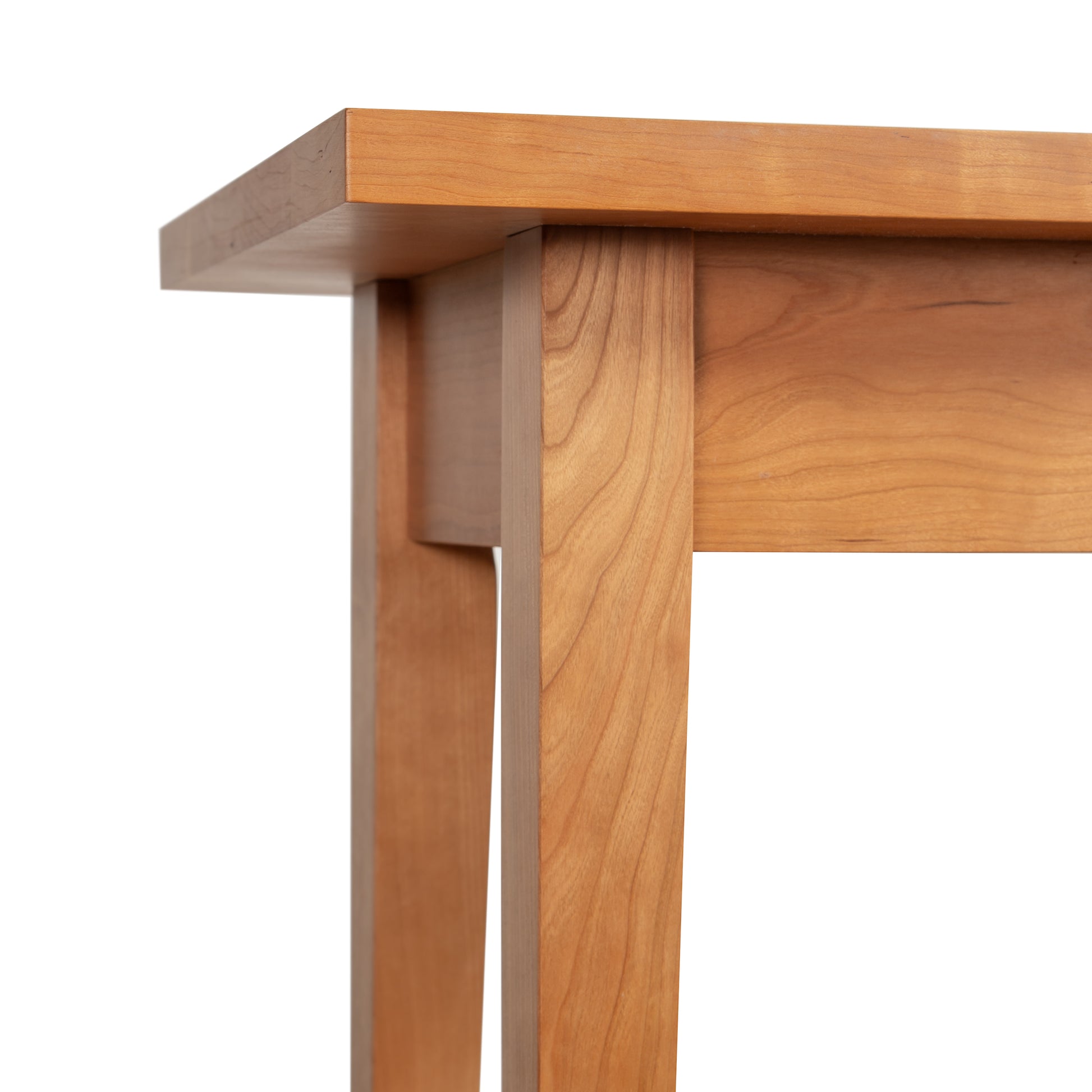 Lyndon Furniture Classic Shaker Sofa Table in natural cherry, highlighting its smooth handcrafted tabletop and elegant tapered legs.