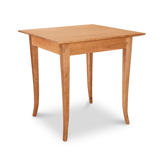 A Lyndon Furniture Classic Shaker Flare Leg Square Solid Top Table made of hardwoods with legs.