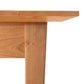 A close up of a Lyndon Furniture Classic Shaker Flare Leg Square Solid Top Table made from hardwoods.
