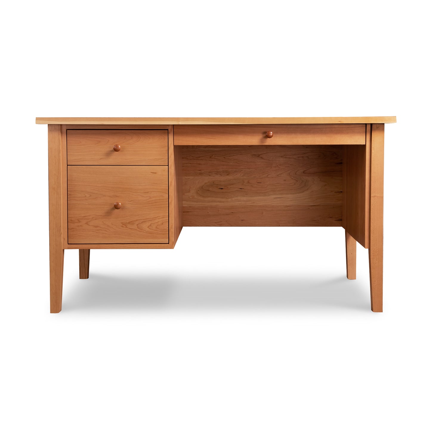 The Lyndon Furniture Small Wood Executive Desk showcases classic Shaker style with a natural finish and minimalist design, crafted from solid wood. This American made desk features two drawers with round knobs on the left and an open space on the right, standing on four straight legs with a smooth, flat surface. Ideal for those seeking Vermont made furniture or solid wood executive desks.