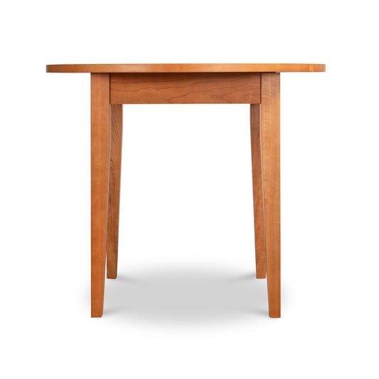 American-made solid hardwood Classic Shaker Round Dining Table featuring a smooth top and tapered legs.