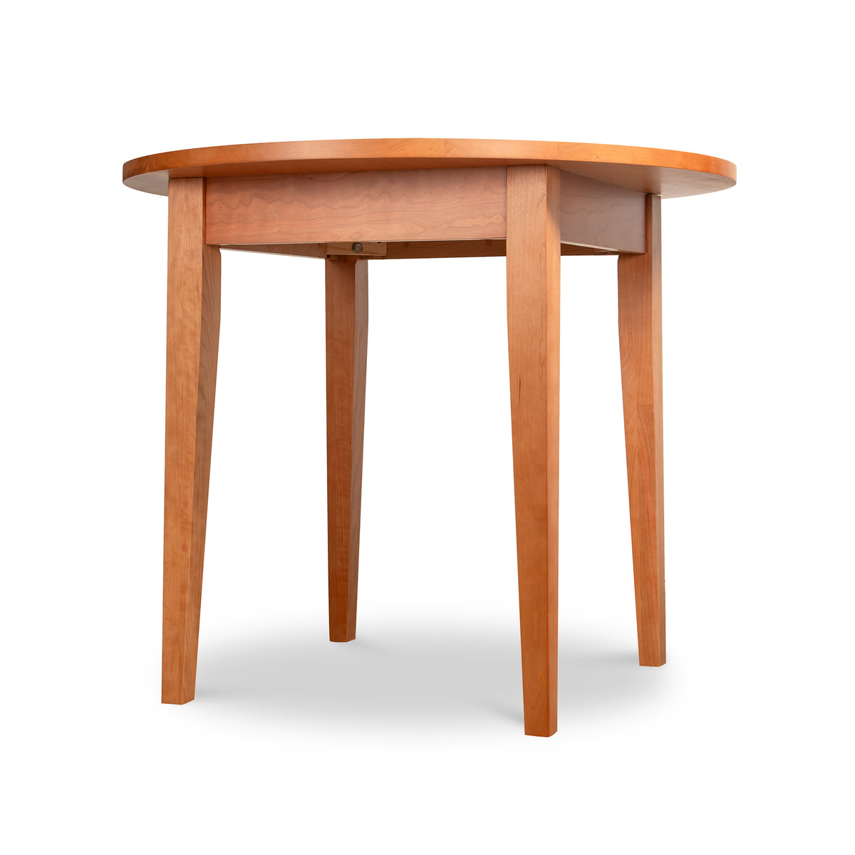 Handmade Classic Shaker Round Solid Top Dining Table featuring solid hardwood construction with a round top and four tapered legs.