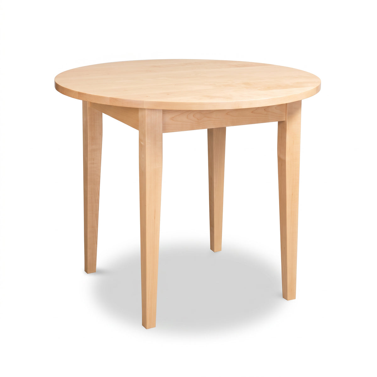 Lyndon Furniture Classic Shaker Round Solid Top Dining Table in solid hardwood with four tapered legs.