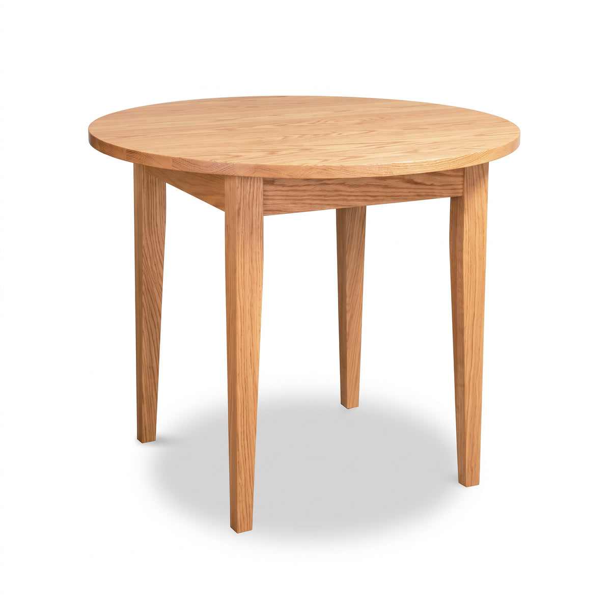 Classic Shaker Round Solid Top Dining Table in oak, featuring a round solid hardwood surface supported by four tapered legs.