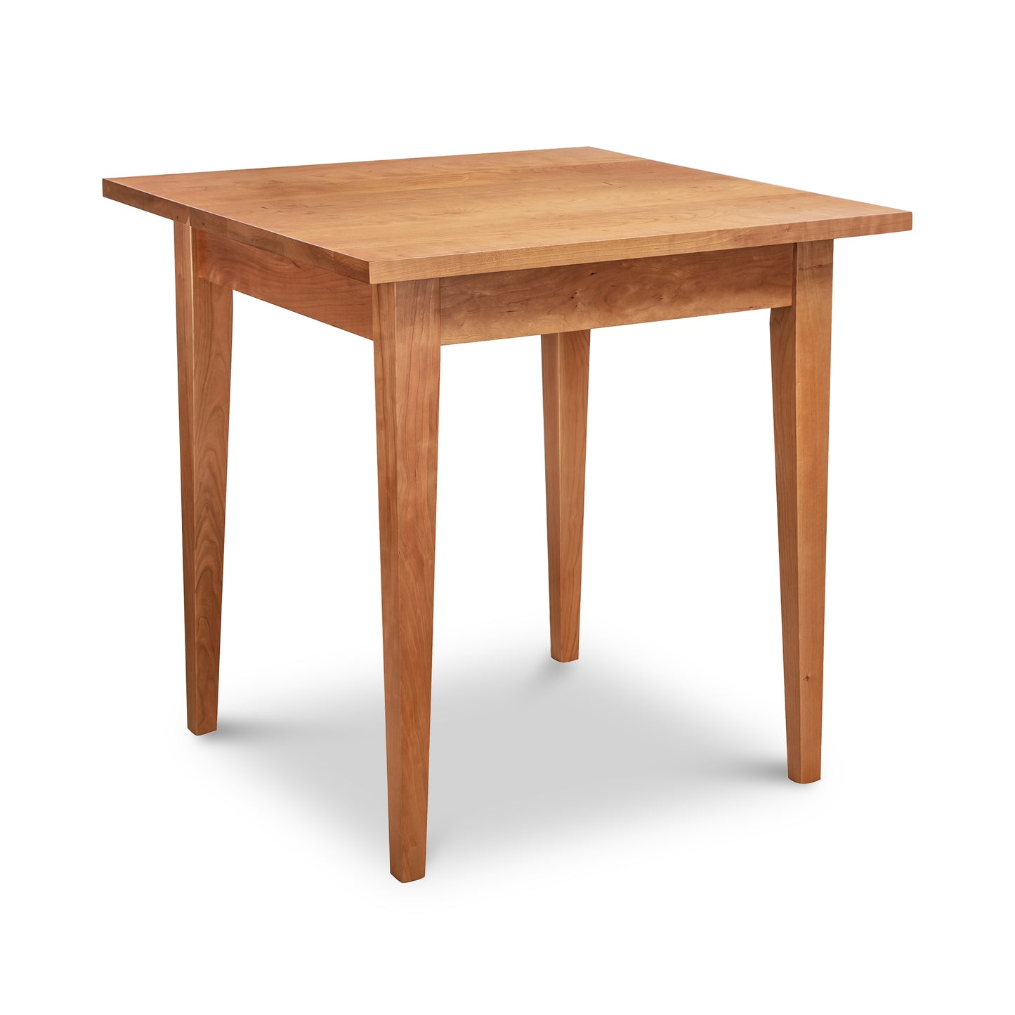 Classic Shaker Square Dining Table by Lyndon Furniture, handcrafted in Vermont from solid cherry wood. This American-made table features a light brown finish, four straight legs, and a smooth flat surface with clean lines, embodying the timeless elegance of shaker furniture.