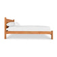 A Classic Wood Bed by Lyndon Furniture with white sheets on it.