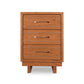 A wooden four-drawer dresser with metal handles and dovetail drawers on a white background by Vermont Furniture Designs.