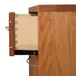 Wooden drawer partially opened from a Contemporary Cable 3-Drawer Nightstand by Vermont Furniture Designs, showcasing dovetail joints, against a white background.