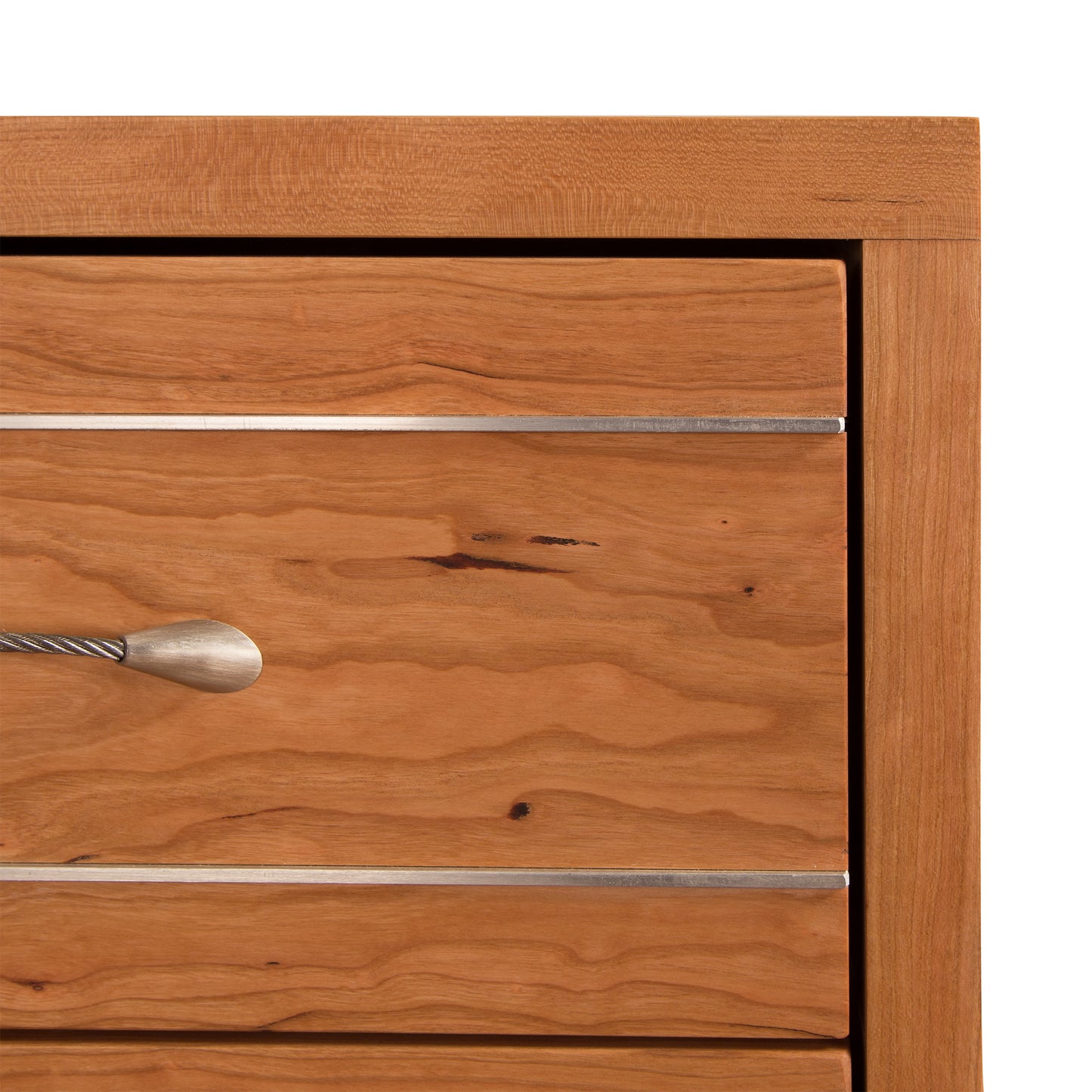 Close-up of a Vermont Furniture Designs Contemporary Cable 3-Drawer Nightstand with a metallic handle.
