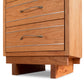 Close-up view of a Vermont Furniture Designs Contemporary Cable 3-Drawer Nightstand with metal handles on the drawers, showing details of the wood grain and dovetail joinery.