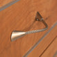 Detail view of the Contemporary Cable 9-Drawer Dresser by Vermont Furniture Designs, highlighting its unique twisted metal drawer pull.