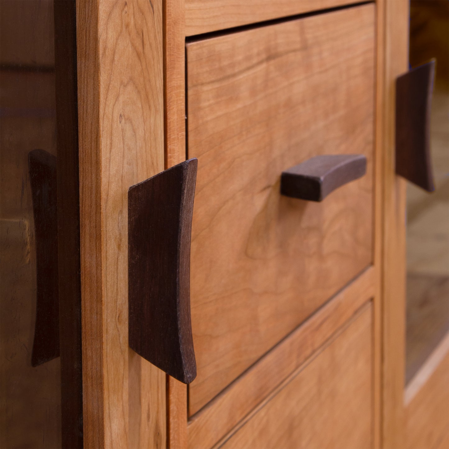 Close-up of a Vermont Furniture Designs Contemporary Craftsman 3-Drawer Media Console with two visible handles.