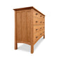 A Vermont Furniture Designs Contemporary Craftsman 8-Drawer Dresser made of natural cherry wood with walnut drawer pulls, isolated on a white background.
