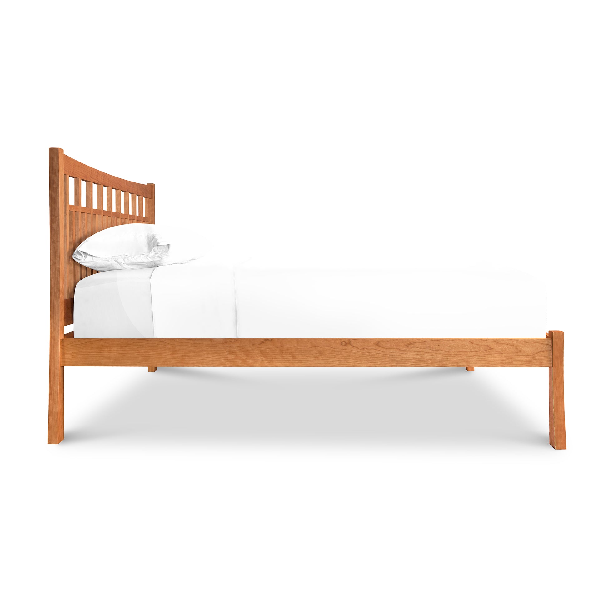 A single Contemporary Craftsman Low Footboard Bed by Vermont Furniture Designs with white bedding against a white background.