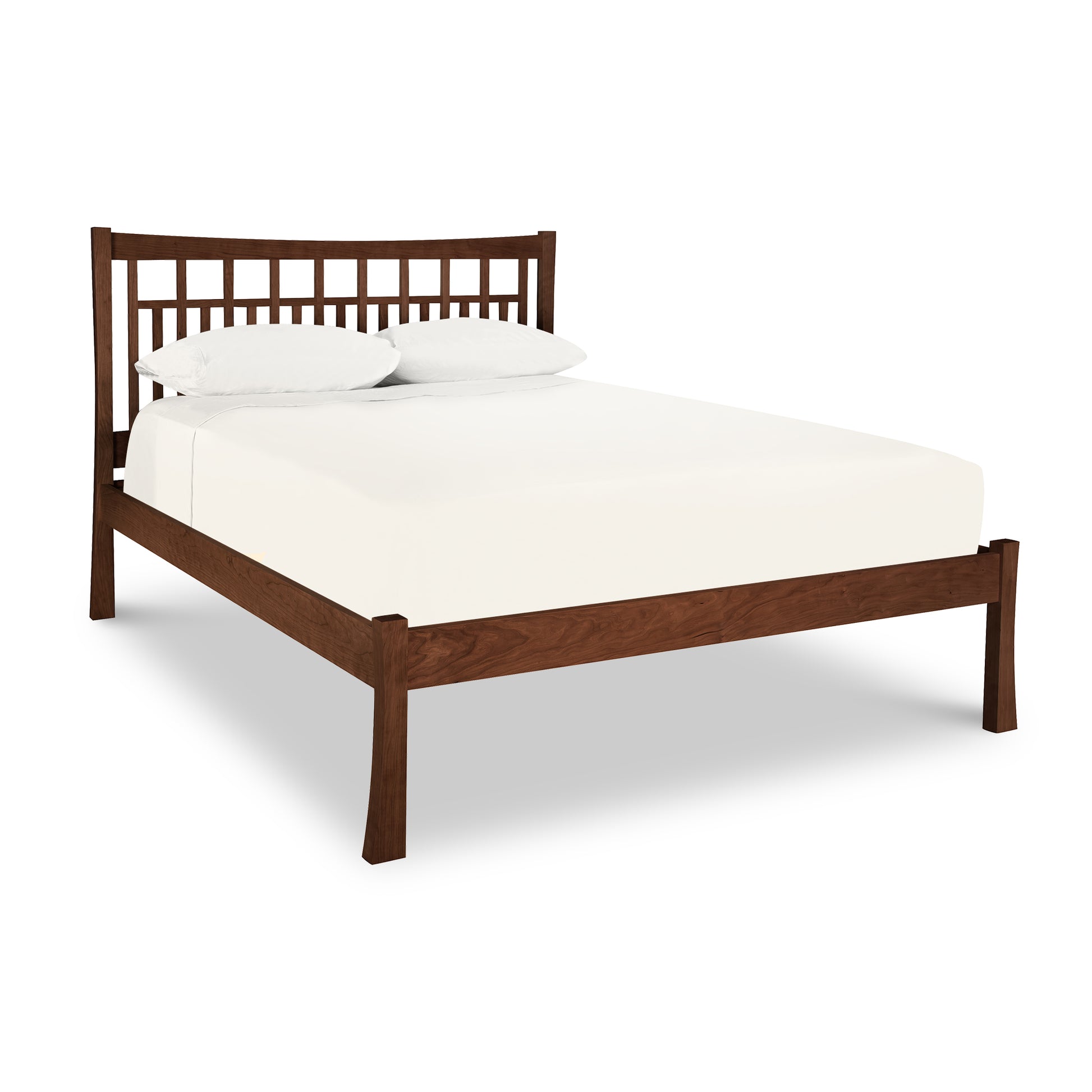 A Vermont Furniture Designs Contemporary Craftsman Low Footboard Bed made from solid wood with an eco-friendly oil finish, including a white mattress and two pillows against a white background.