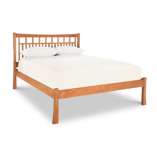 Alt text: Queen-size Contemporary Craftsman Low Footboard Bed by Vermont Furniture Designs - Ready to Ship, featuring a wooden frame with light brown finish, slatted headboard, dressed in white sheets and pillowcases on a matching mattress. Ideal for any contemporary bedroom decor. Photographed against a white background – solid wood furniture from American made furniture experts.