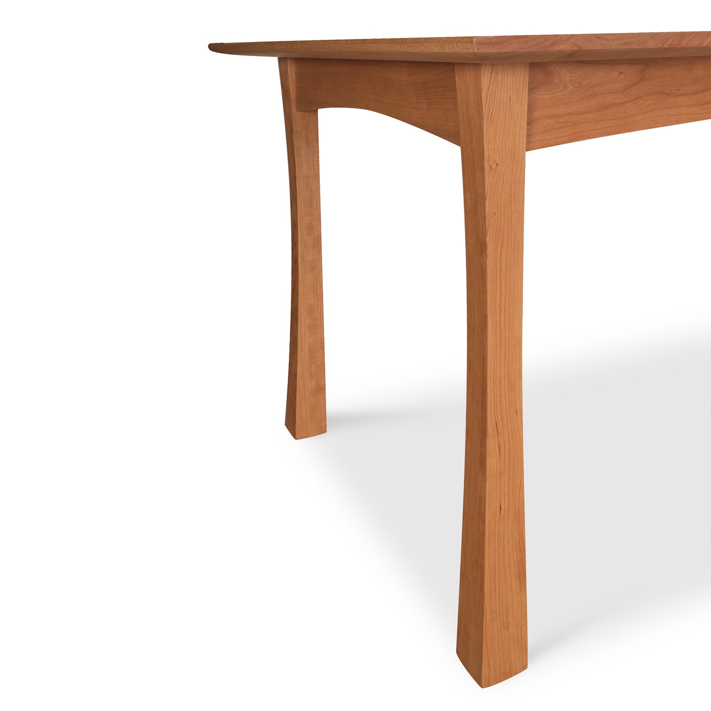 A Vermont Furniture Designs Contemporary Craftsman Solid Top Dining Table with one leg visible, shown in partial view against a white background.