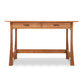 A Vermont Furniture Designs Contemporary Craftsman Writing Desk with two drawers and slanted legs, featuring an eco-friendly oil finish, isolated on a white background.