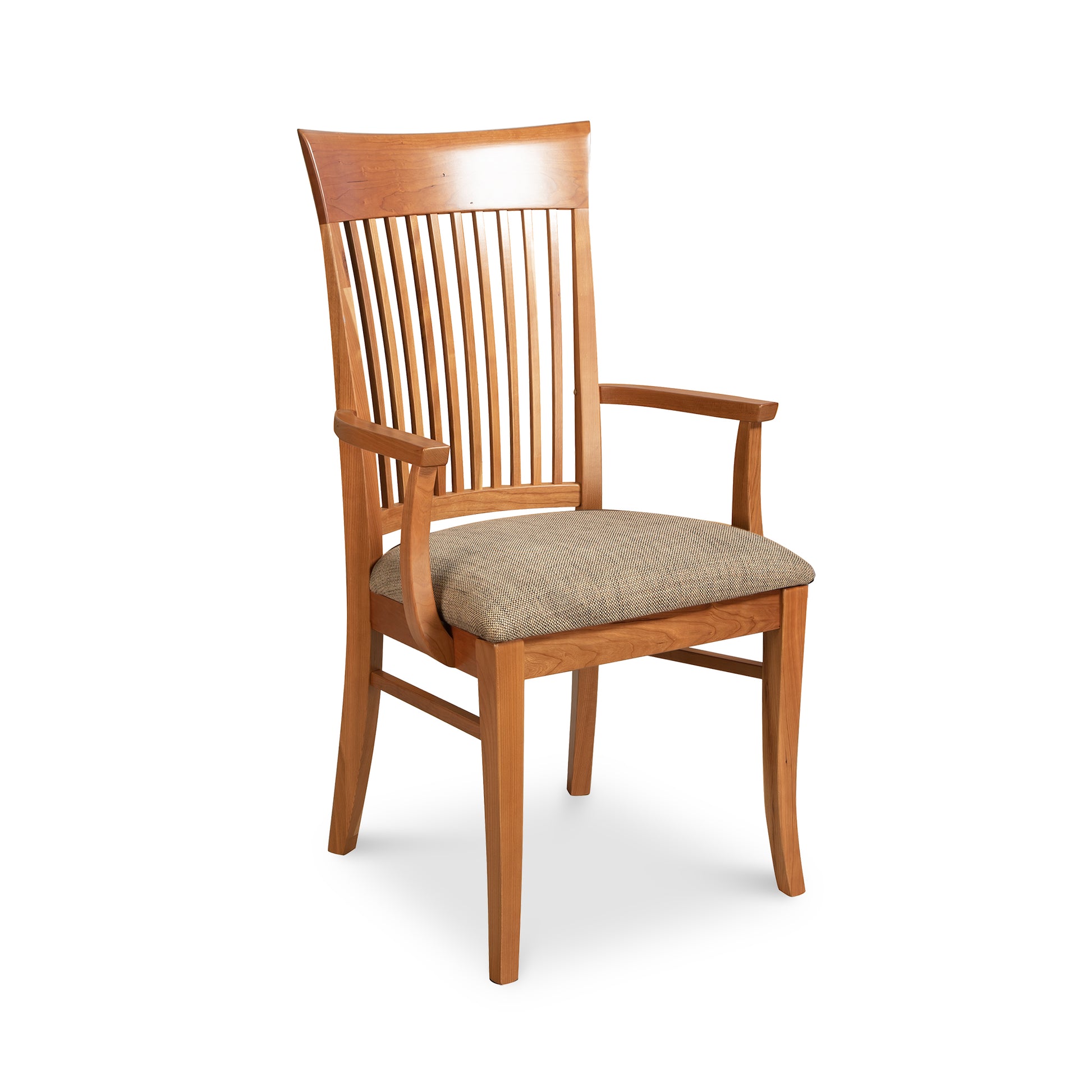 A Contemporary Shaker Chair with armrests, featuring vertical slats on the back and a cushioned seat with a beige fabric cover, crafted from natural cherry wood, isolated on a white background by Vermont Woods Studios.