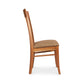 A wooden dining chair with a tan upholstered seat.