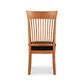 A Vermont Woods Studios contemporary Shaker chair with a tall, slatted back and a dark seat cushion, isolated on a white background.