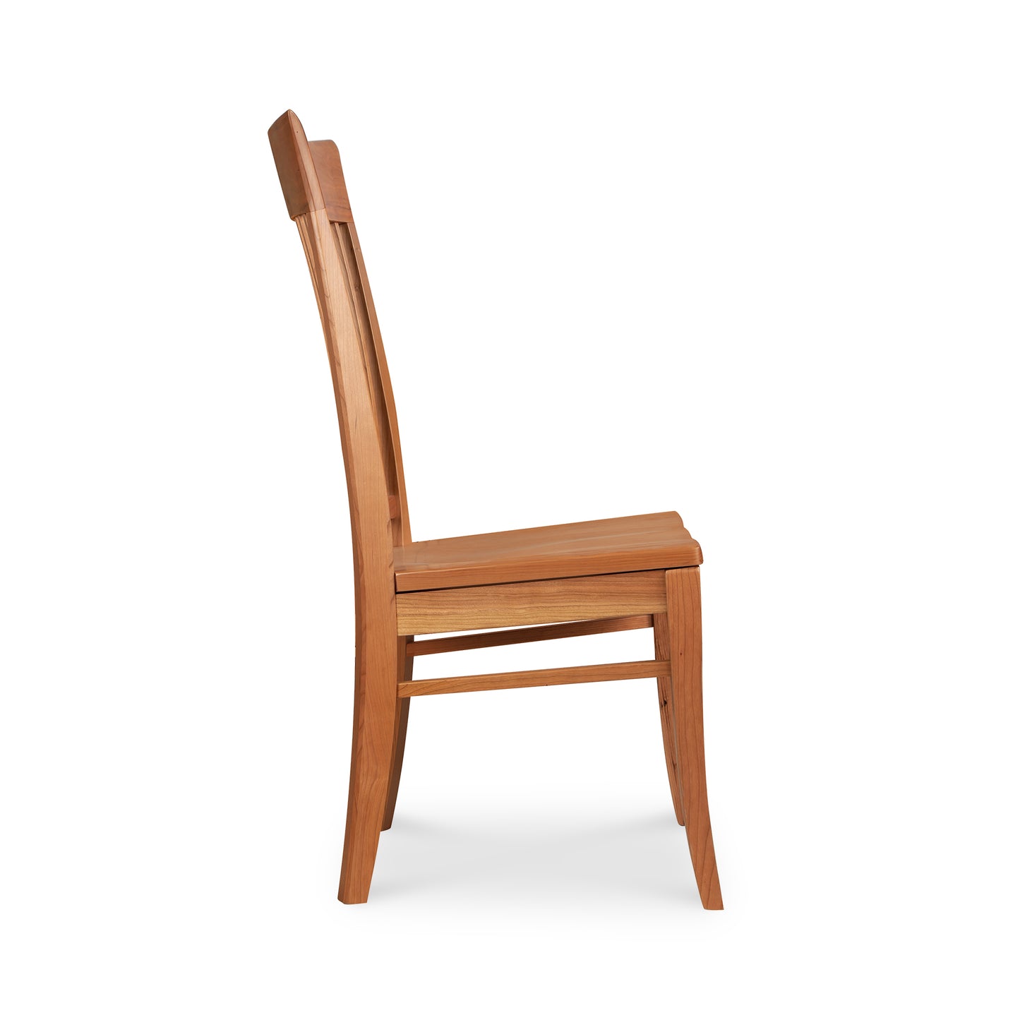 A Contemporary Shaker Side Chair with a tall, slightly curved backrest is shown in a side profile. The chair features a simple design with a flat wood seat and four straight legs, reinforced by horizontal supports. Sustainably handcrafted by Vermont Woods Studios, this display model has a light, natural cherry finish.