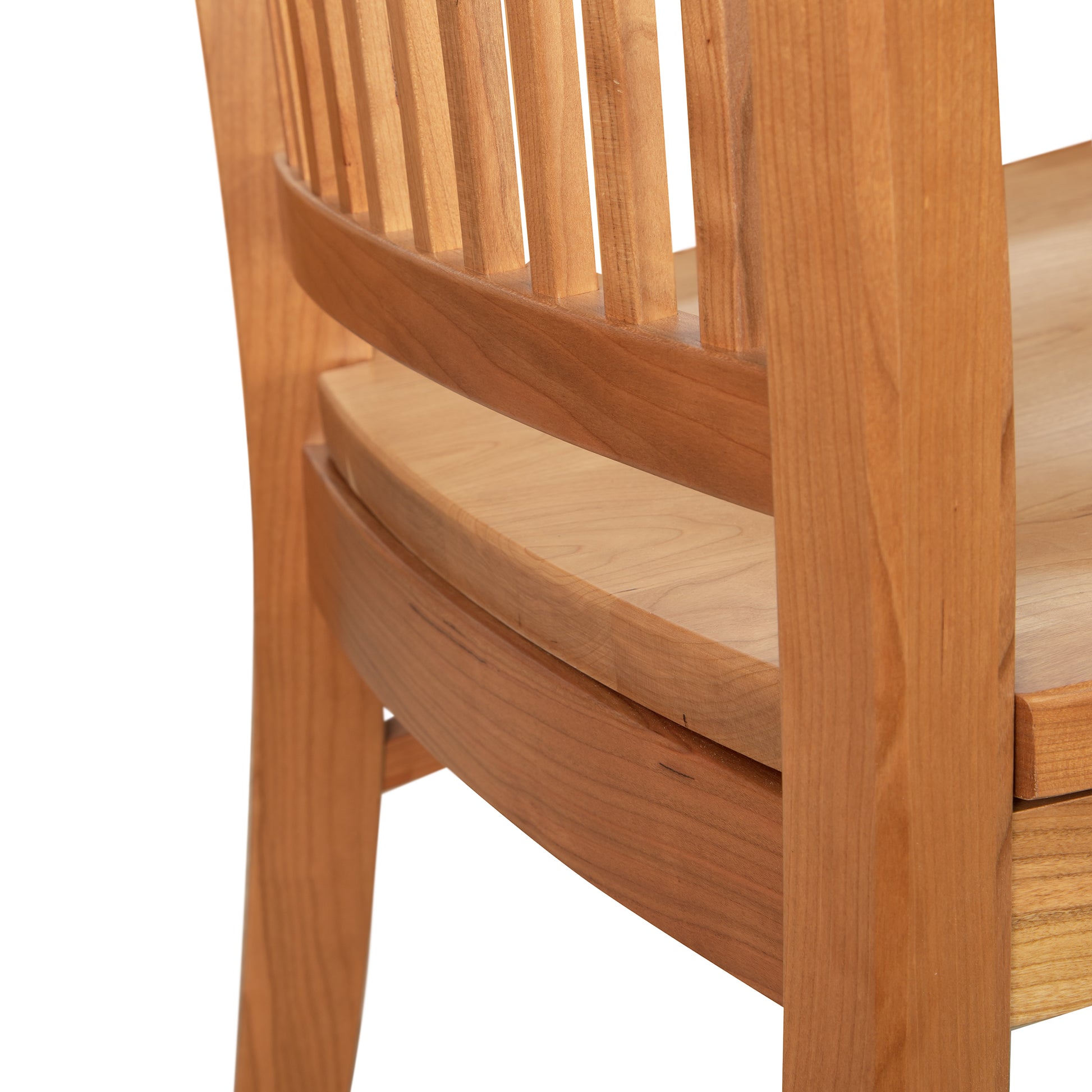 Close-up of the Contemporary Shaker Side Chair with Wood Seat - Display Model by Vermont Woods Studios, showcasing the light brown backrest with vertical slats and a slightly curved design. The wooden seat matches the backrest in both color and texture. The focus is on the craftsmanship and wood grain.