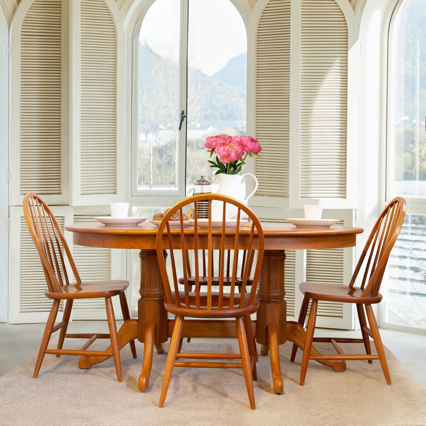 Solid wood dining table paired with Lyndon's Windsor Chairs, showcasing elegant craftsmanship.