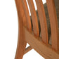 A close up of a wooden chair with a fabric seat.