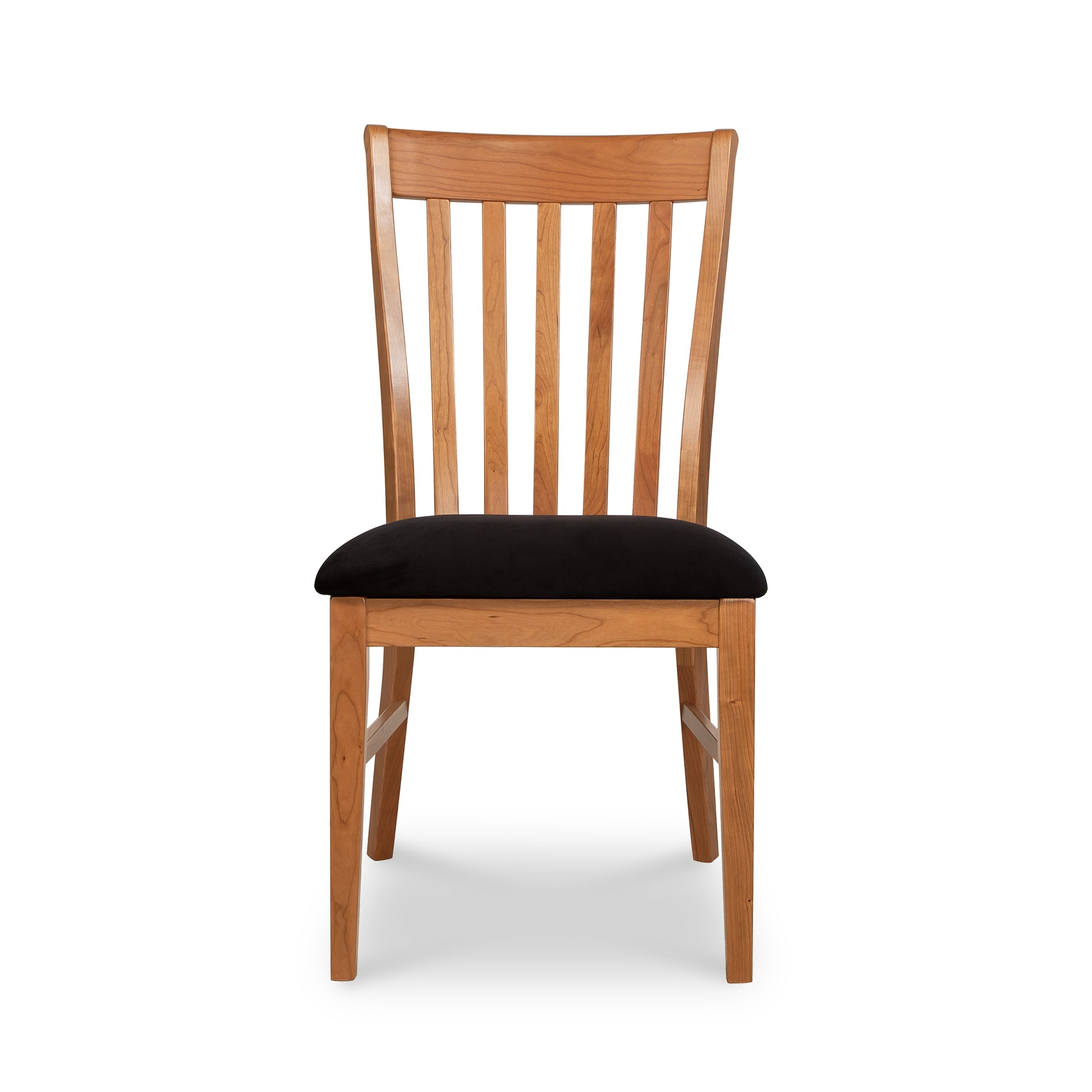 A wooden dining chair with black cushion.