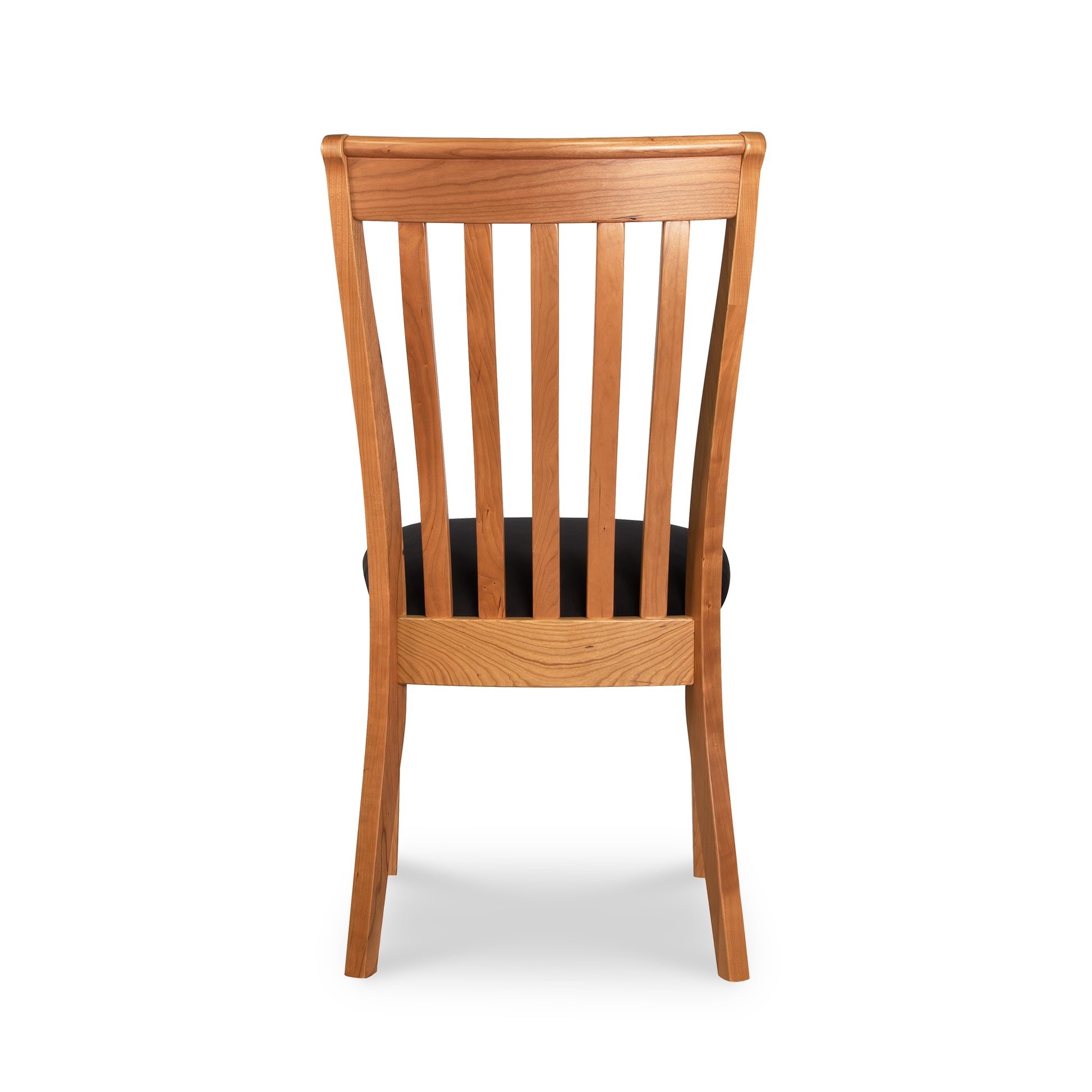 A wooden dining chair with black seat and back.