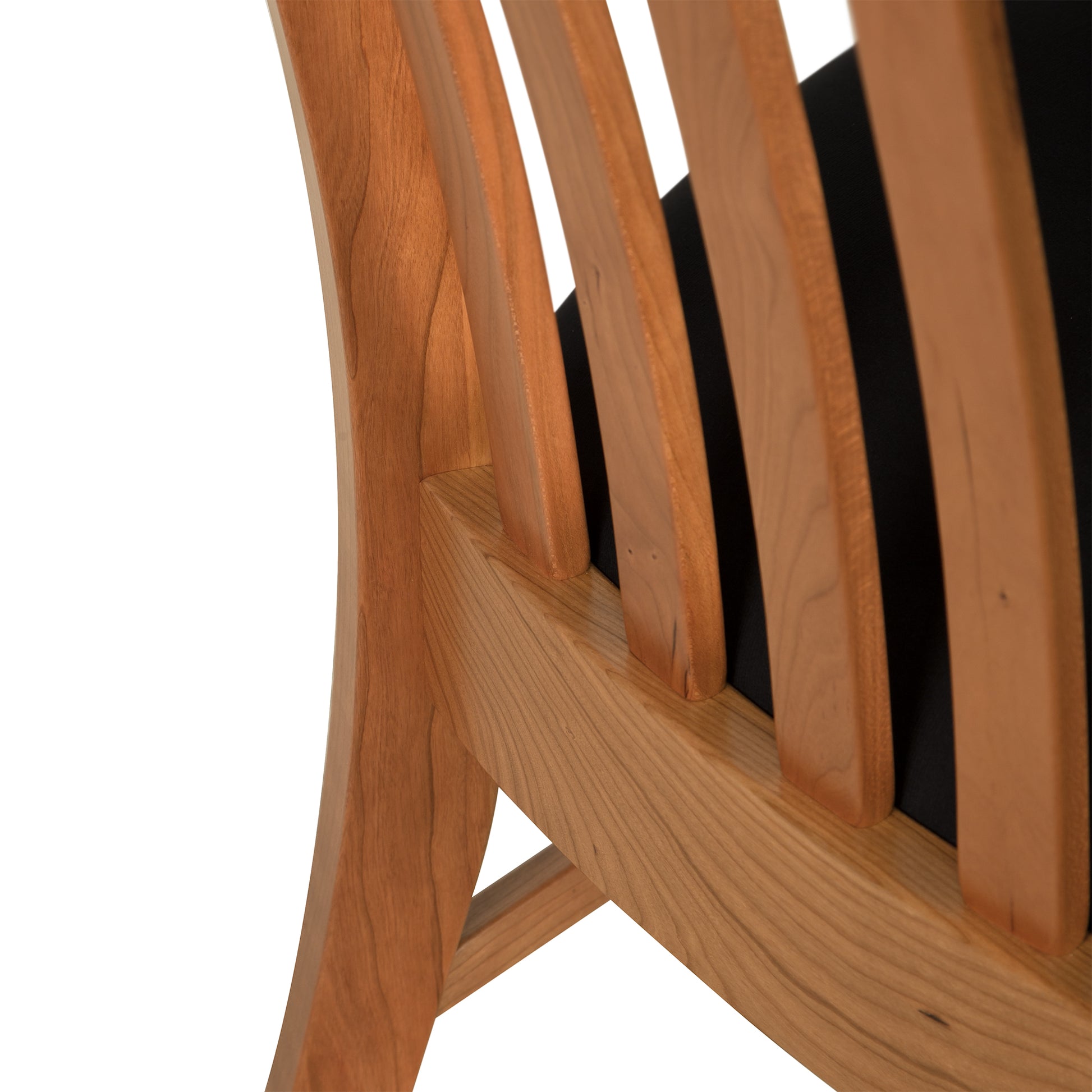 Close-up of a Vermont Woods Studios Country Shaker Chair showing the detailed craftsmanship of the smooth, curved frame and the vertical slats against a white background.
