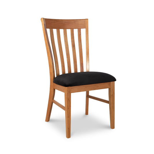 A Vermont Woods Studios Country Shaker Chair with a high, slatted back and a black upholstered seat cushion, isolated against a white background.