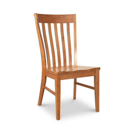 A Vermont Woods Studios Country Shaker Chair with Wood Seat, featuring a tall slatted backrest with lumbar support and a solid seat, positioned on a white background.