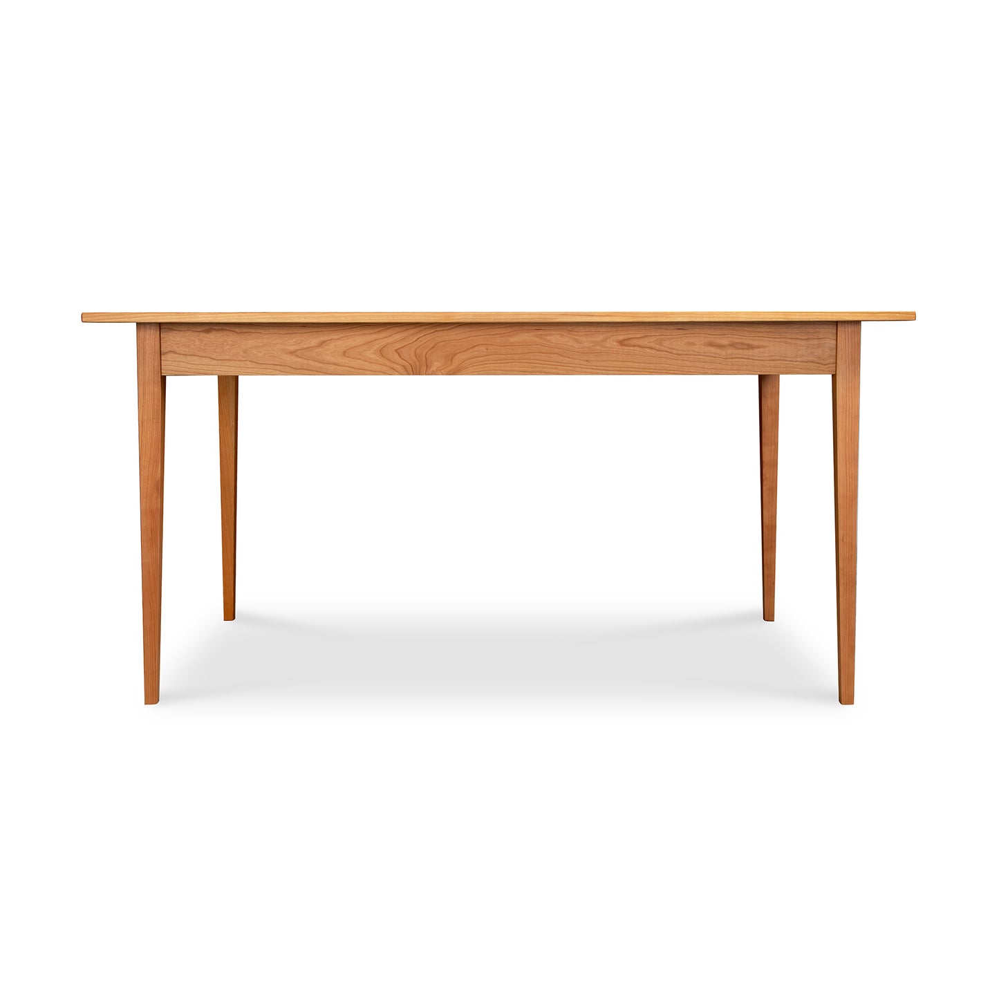 A Country Shaker Dining Table with a solid natural wood top on a white background by Vermont Woods Studios.