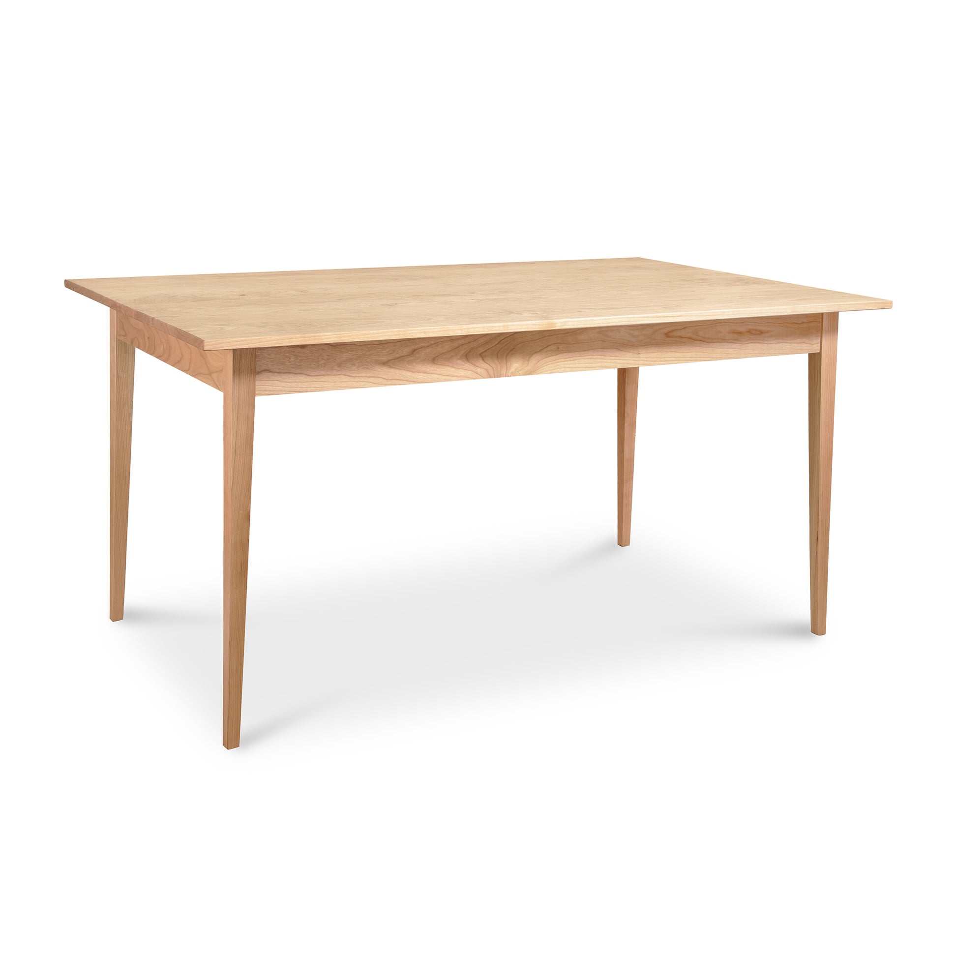 A Vermont Woods Studios Country Shaker Dining Table with a solid natural wood top and legs, available in various wood options.